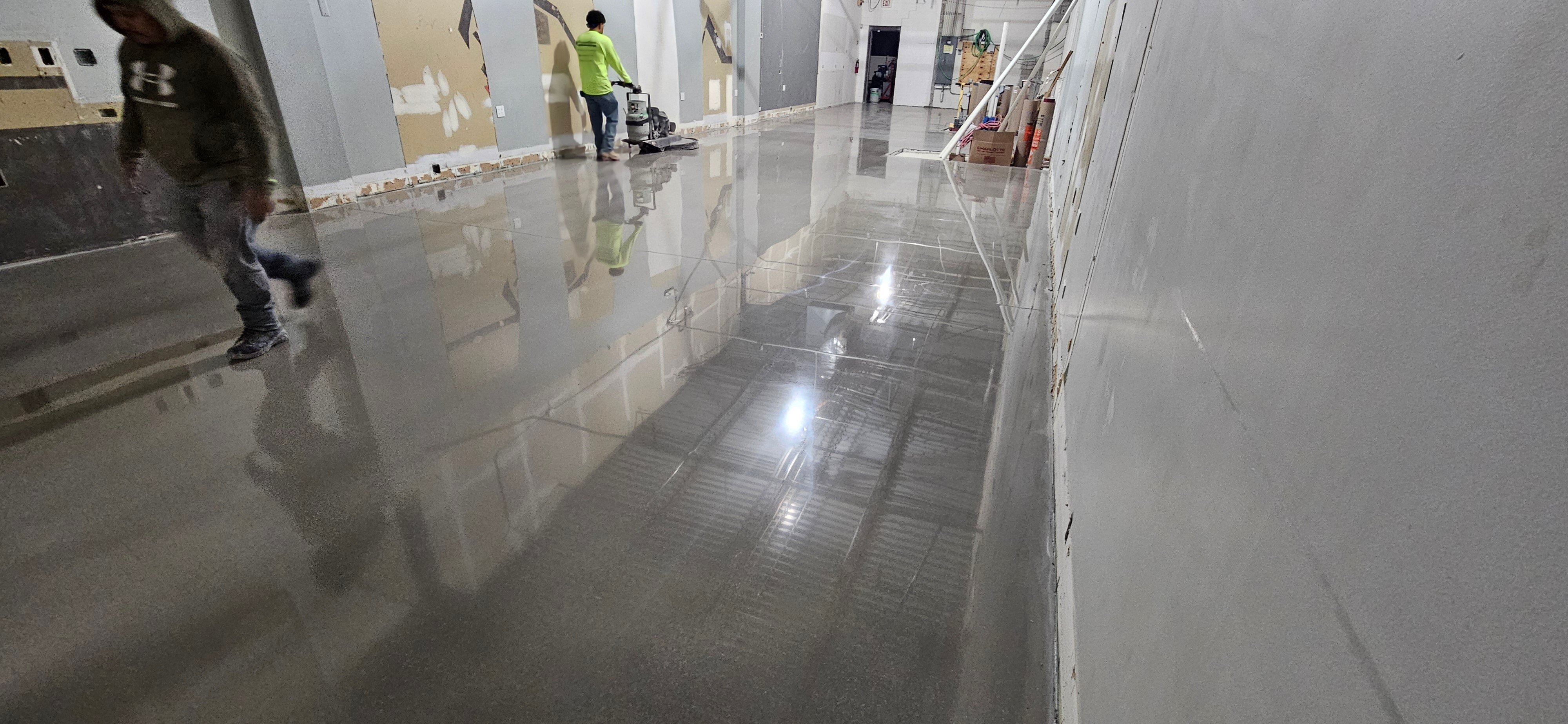 CustomCrete worker polishes a polished overaly concrete floor in a facility in Chicago