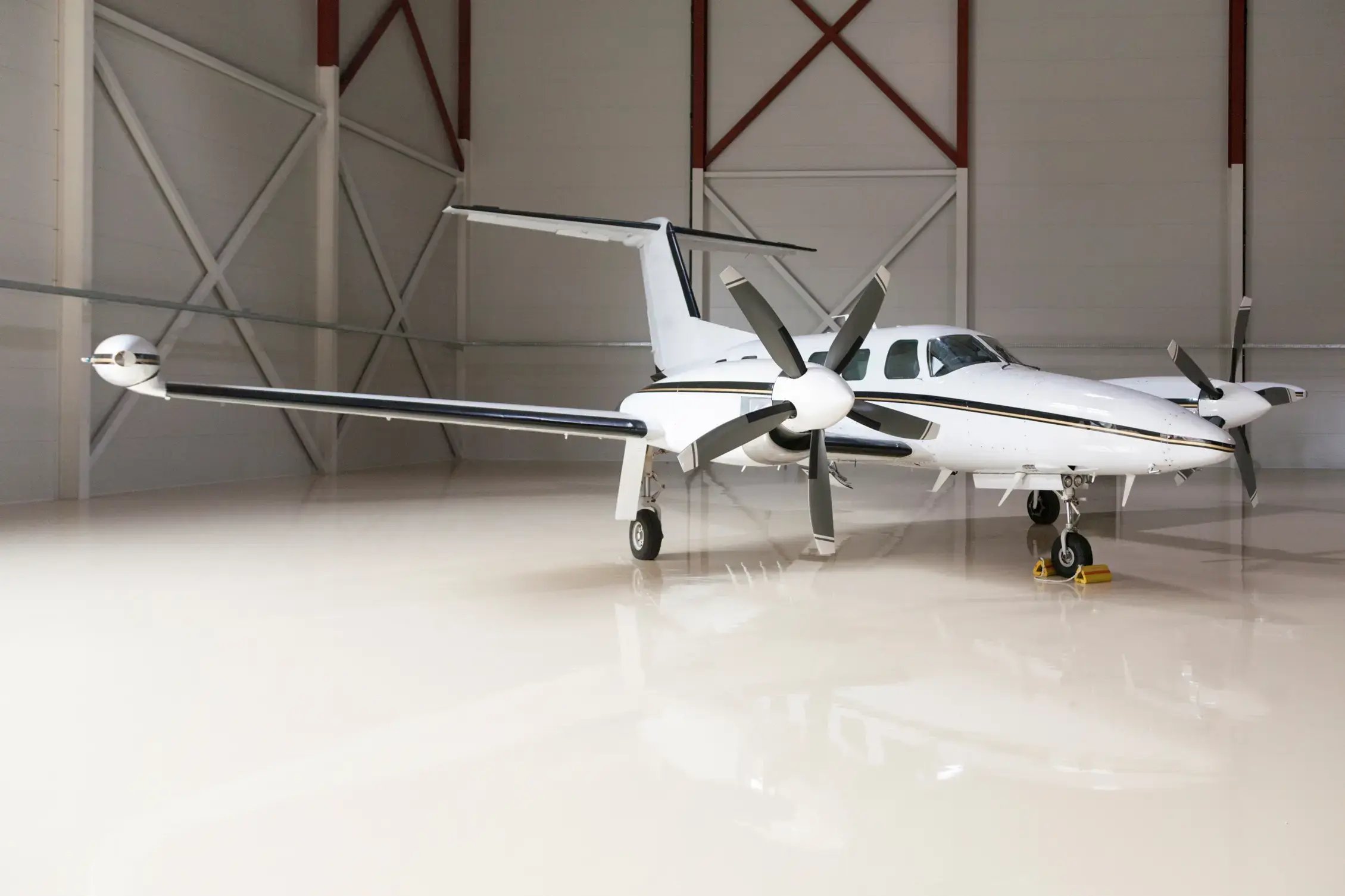 epoxy floor in an airplane hanger with a small prop plane