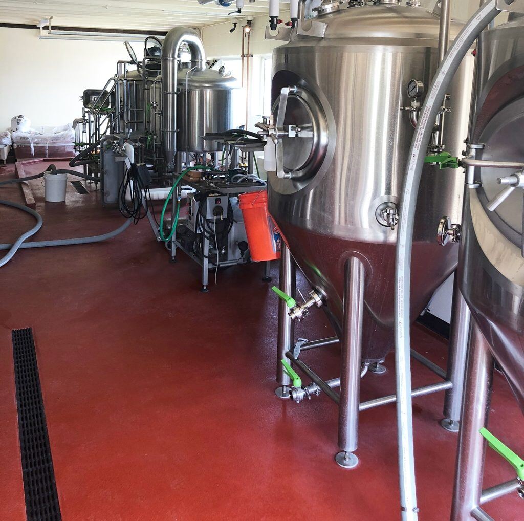 storage tanks in a food plant with red urethane cement flooring