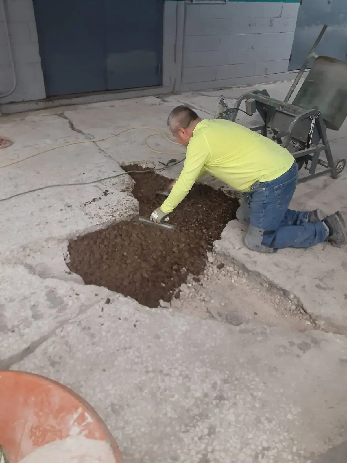 customcrete worker fills a large crack in concrete floor, illinois plant