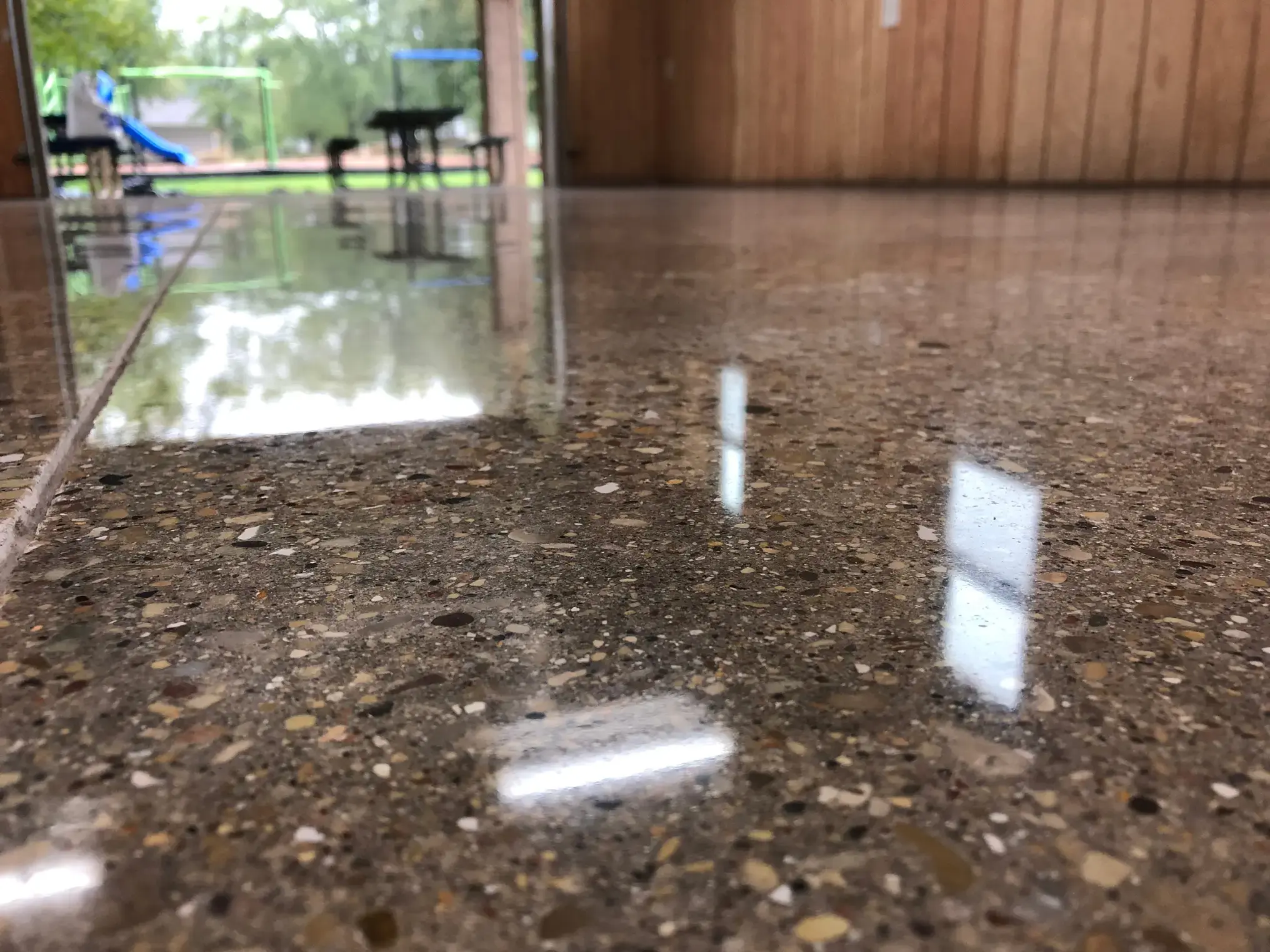 Polished Concrete flooring with a double door looking out onto a park