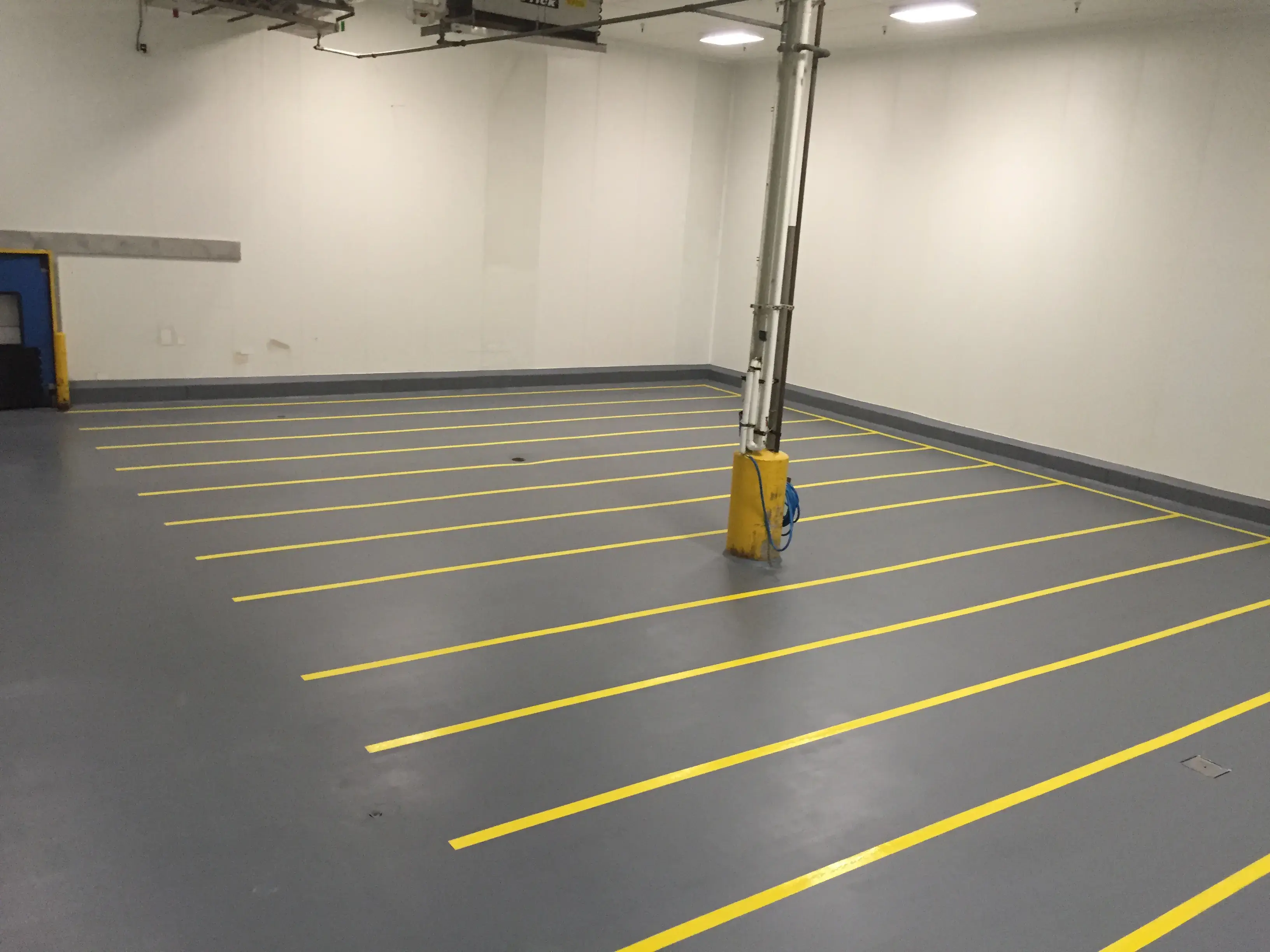 grey Urethane Cement with yellow safety lines 