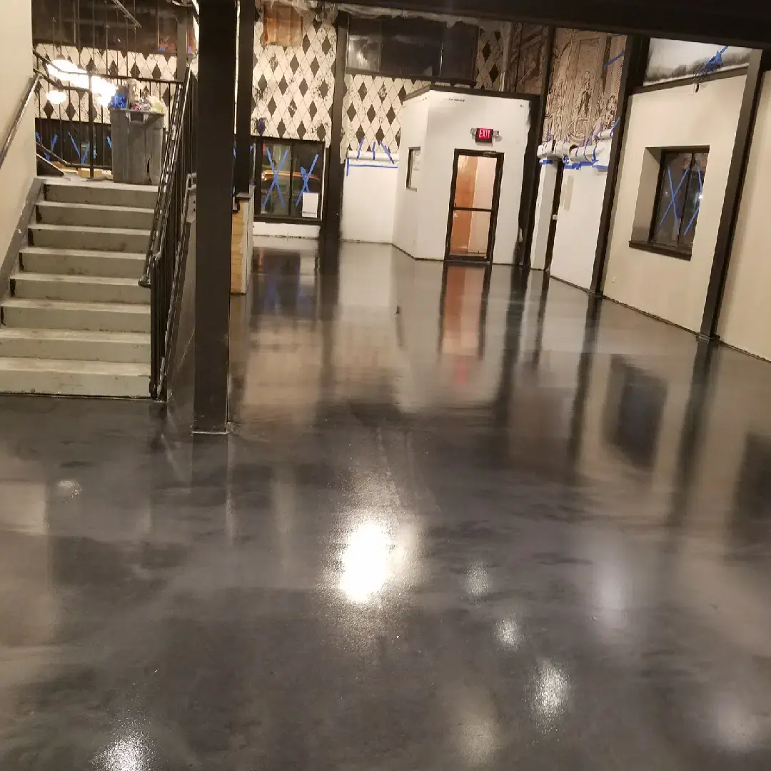 hallway with stairs with a grey Epoxy floor in a renovated building 